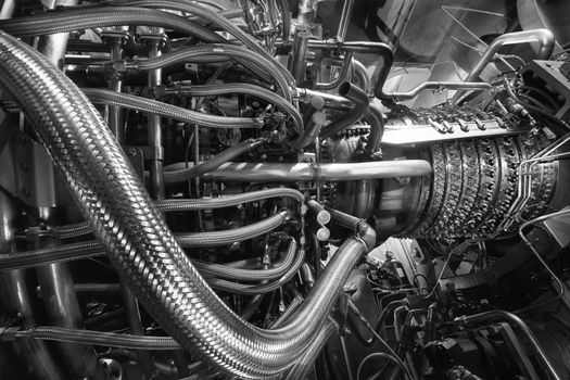 Gas turbine engine of feed gas compressor located inside pressurized enclosure, Black white monochrome. The gas turbine engine used in offshore oil and gas central processing platform. Technological ecological installation