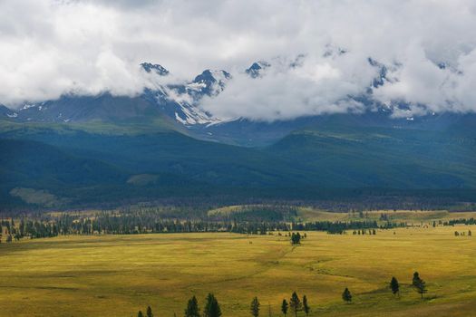 Scenic view of the snow-covered North-Chuya range in the Altai mountains in the summer, Siberia, Russia.