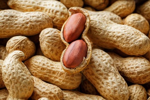 Peeled peanut on well peanuts. Uncleaned inshell peanuts. Peanuts, for background or textures.