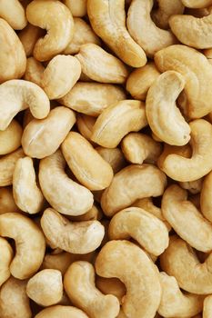 Organic cashew without shell on the background. Organic golden walnut closeup. Macro shot plan.