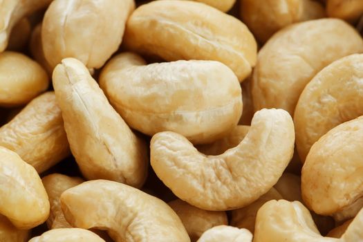 Organic cashew without shell on the background. Organic golden walnut closeup. Macro shot plan.