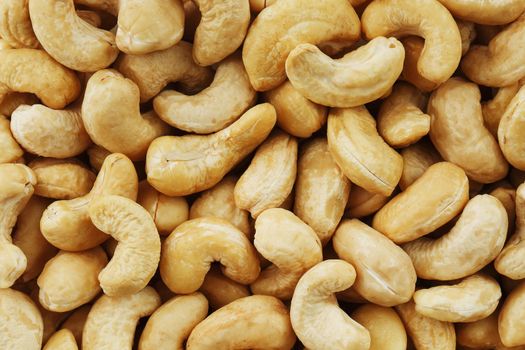 Organic cashew without shell on the background. Organic golden walnut closeup. Macro shot plan.