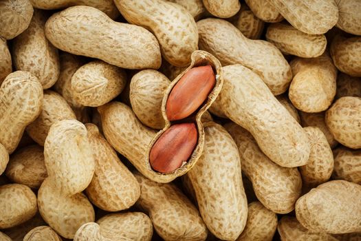 Peeled peanut on well peanuts. Uncleaned inshell peanuts. Peanuts, for background or textures.