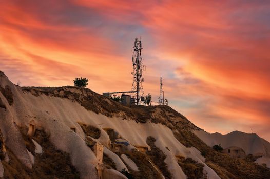 Aerial view of Telecommunication mast TV antennas at sunset on mountain