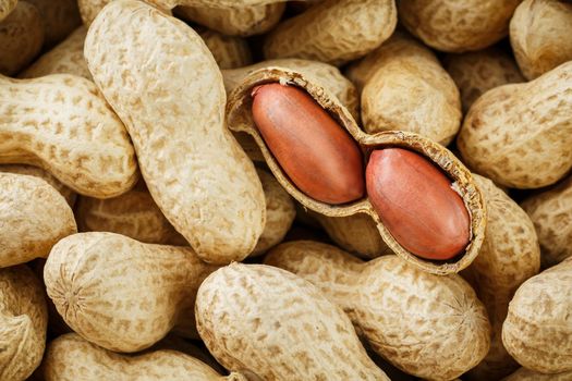 Peeled peanut on well peanuts. Uncleaned inshell peanuts. Peanuts, for background or textures.