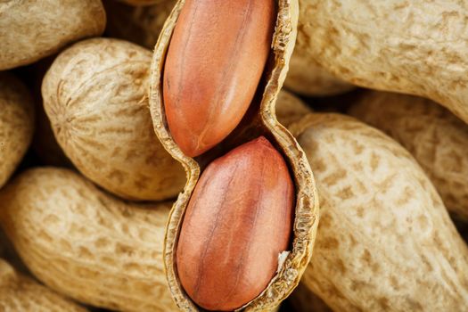 Peeled peanut on well peanuts. Uncleaned inshell peanuts. Peanuts, for background or textures.