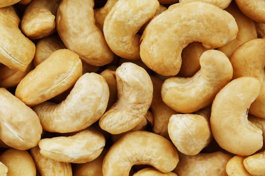 Organic cashew without shell on the background. Organic golden walnut closeup. Macro shot plan.