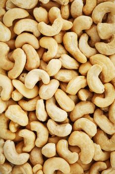 Organic cashew without shell on the background. Organic golden walnut closeup. Macro shot plan.