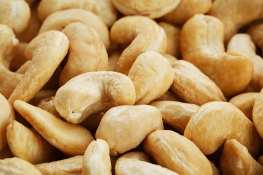 Organic cashew without shell on the background. Organic golden walnut closeup. Macro shot plan.