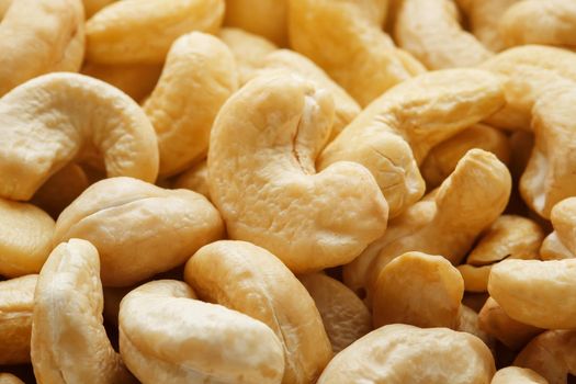 Organic cashew without shell on the background. Organic golden walnut closeup. Macro shot plan.