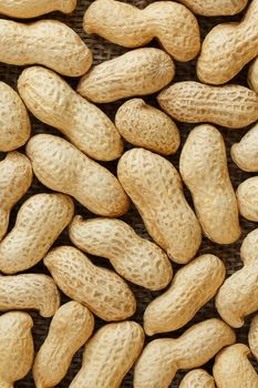 Peanuts in their food texture background. Golden shell roasted peanuts. Organic Vegan Protein Source.