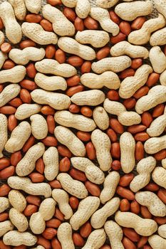 Peanuts in a shell mixed with peeled, the texture of the food background of beans. Organic Vegan Protein Source