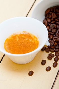 italian espresso cofee and beans on a white wood table 