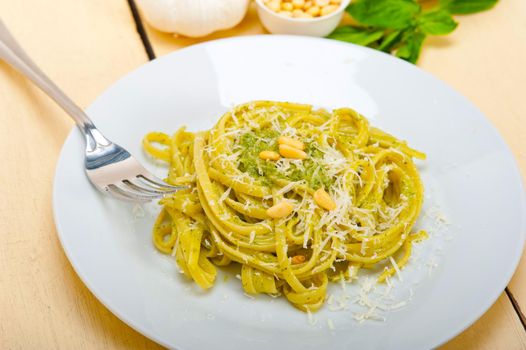 Italian traditional basil pesto pasta ingredients parmesan cheese pine nuts extra virgin olive oil garlic on a rustic table 