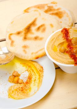 traditional chickpeas Hummus with pita bread and paprika on top 