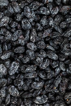 Black Raisin texture, popular dried fruit. Dried grapes. Red seedless raisins from grapes