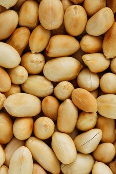 Peanut texture. Food background of peanuts bean. Golden, roasted organic peanuts. Wholesome organic legumes. Close-up, macro.