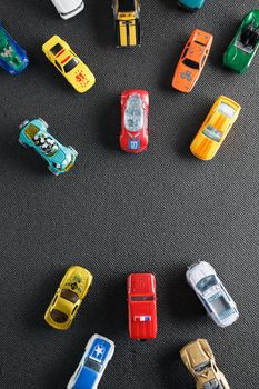 Colorful automotive toys. The apartment was lying, on a gray background.