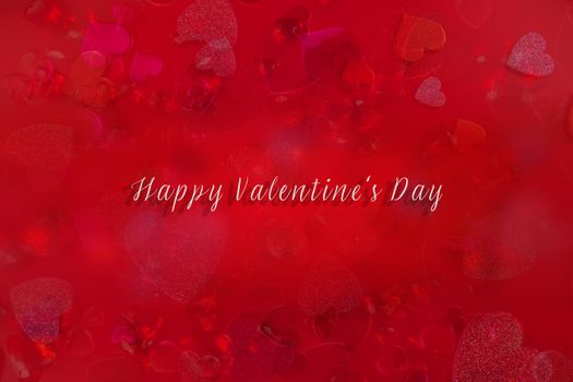 Valentine's Day Heart Abstract Multiple Exposure Background. Predominantly red image with hearts of different sizes, colors, and textures, including shiny, glittery, and gemstone. Lots of copy space. Includes the words, Happy Valentine's Day