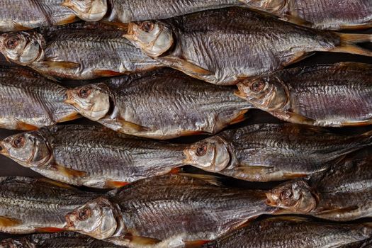 Lots of dried or jerky salted taranka. Fishes background. Salty beer appetizer. Traditional way of preserving fish. Close up, top view