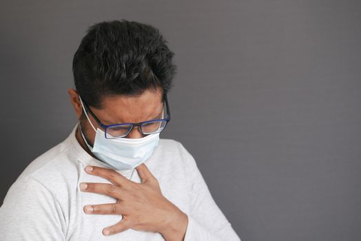 Portrait of sick man sneezes and coughs,