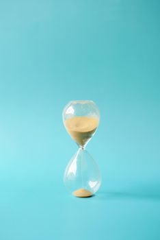 hourglass on table, Sand flowing through the bulb of Sandglass.