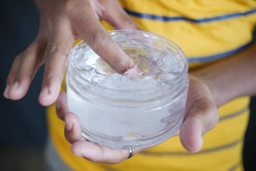 hand hold a jar of hair gel