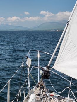 On a sailing yacht approaching Lismore lighthouse on Eilean Musdile in the Firth of Lorne at the entrance to Loch Linnhe, Hebrides, Scotland, UK
