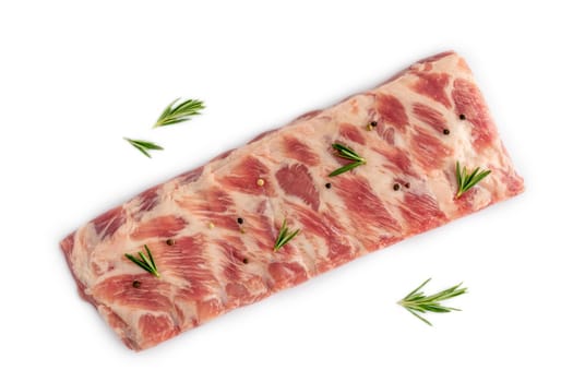 Closeup of raw spare lamb ribs with rosemary herbs and pepper on white isolated studio background. Barbecue uncooked meat. Protein nutritious market fat bone. Delicious mutton steak for dinner