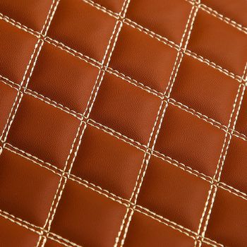 Texture of brown leather background with square pattern and stitch, macro