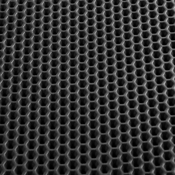 Texture of black leather background with honeycomb shape pattern, macro