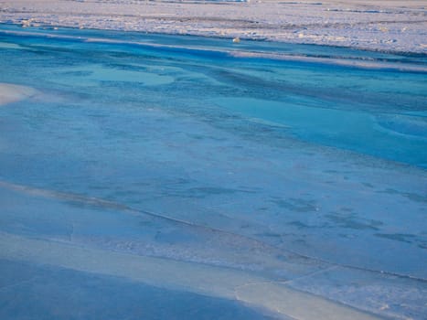 Network of cracks in thick solid layer of ice of a frozen river