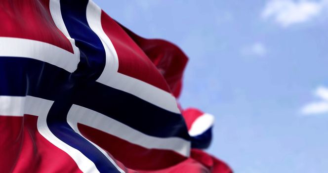 Detail of the national flag of Norway waving in the wind on a clear day. Democracy and politics. North European country. Selective focus.