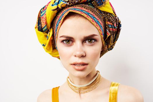 cheerful pretty woman in multicolored turban african style and fashion posing. High quality photo