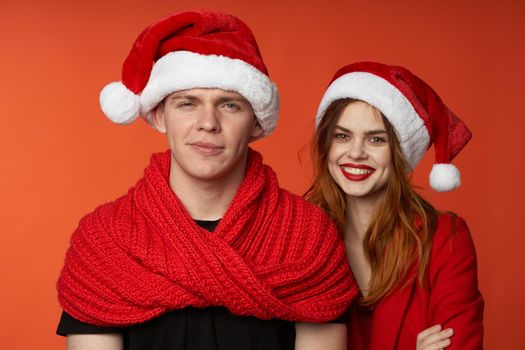 family in santa hats fun new year holiday red background. High quality photo