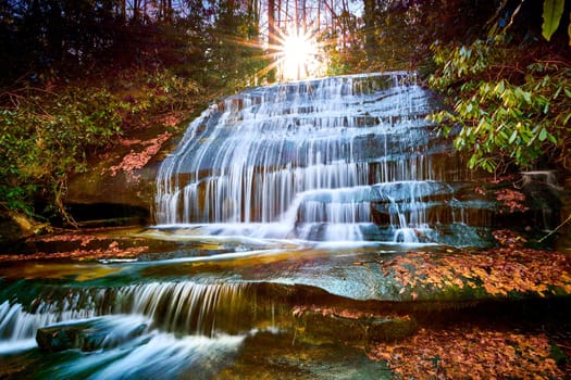 Sun setting over Grogan Creek Falls (or Falls on Grogan Creek) located in Pisgah National Forest near Brevard NC.