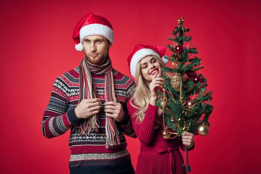 man and woman in New Year's clothes fun Christmas tree decoration portrait. High quality photo