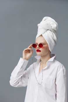 portrait of a woman with a towel on his head in a white shirt isolated background. High quality photo