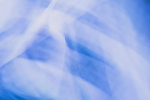 Horizontal blue white abstract background banner with light blur. Backdrop of waves of highlights and lines.