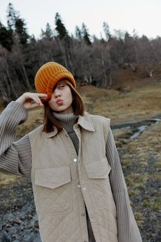 young woman in the autumn forest walk fresh air travel life style. High quality photo