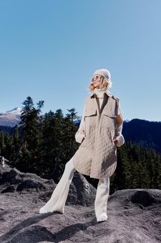 Stylish woman Cliffs mountains fashion posing nature fresh air landscape. High quality photo