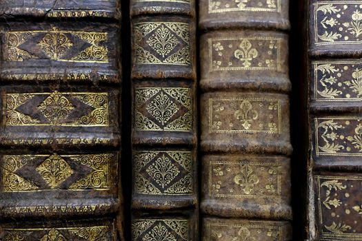 Old worn books on a shelf in the library's archives