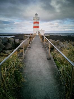 Lighthouse and path under cloudy day