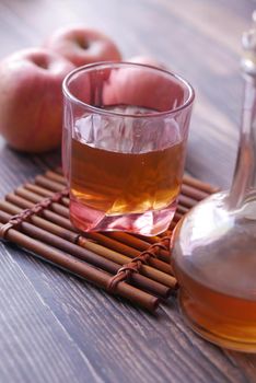 apple vinegar in glass bottle with fresh green apple on table ,