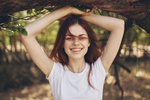 pretty woman sitting near a tree landscape. High quality photo