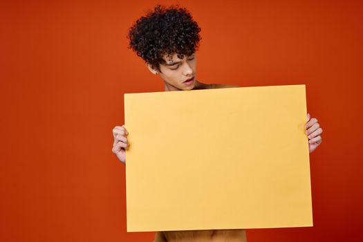 guy holding a banner isolated background studio copy-space. High quality photo