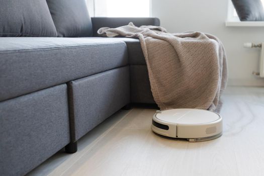 robotic vacuum cleaner on laminate wood floor smart cleaning technology.