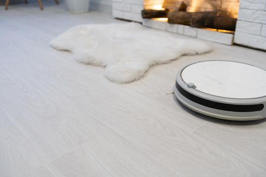Automated vacuum cleaning robot powered by rechargeable battery in modern living room.