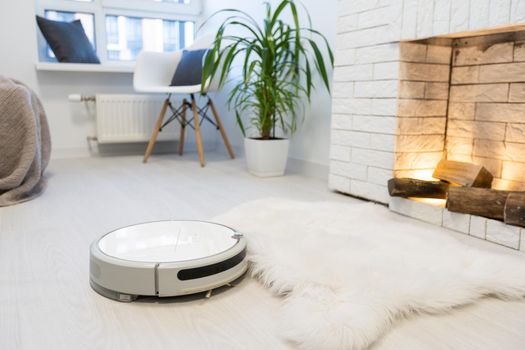 Automated vacuum cleaning robot powered by rechargeable battery in modern living room.