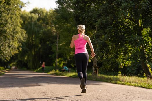Jogging woman running in park.